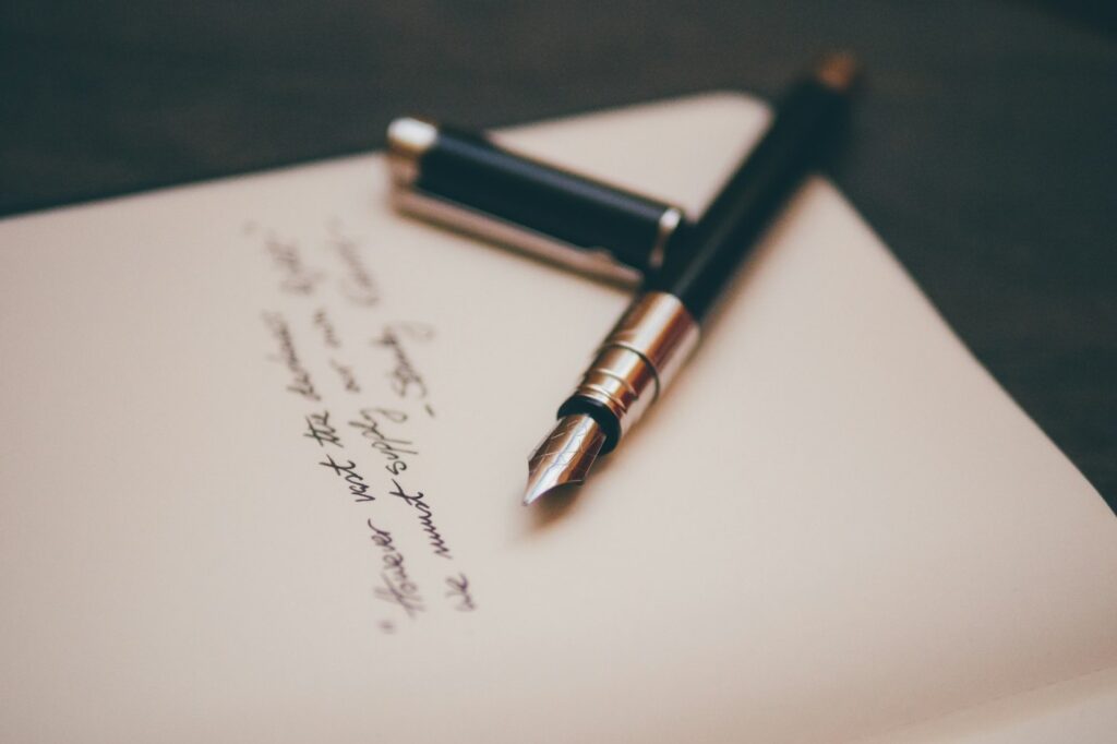 A fountain pen resting on writing paper