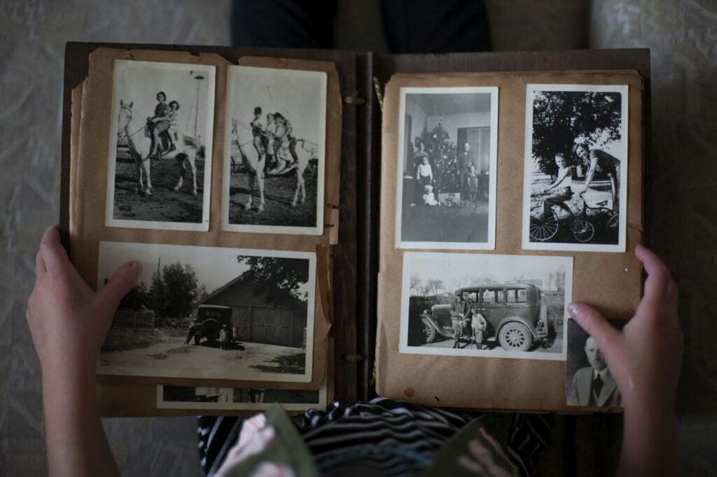 Hands turning the pages of an old photo album