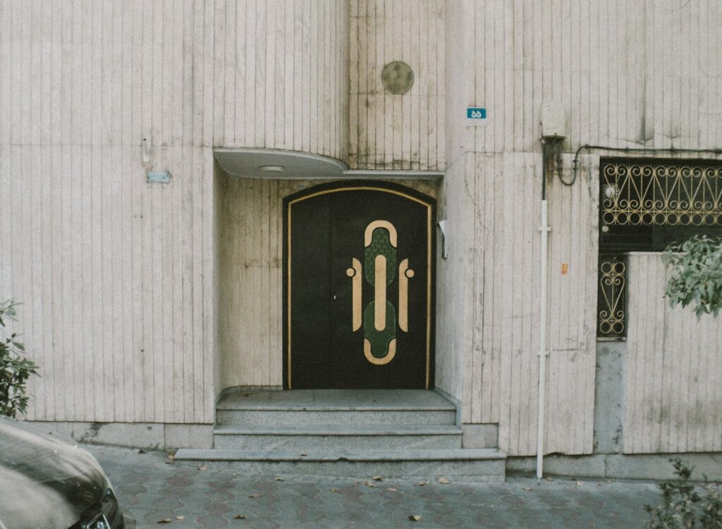 An ornate black and gold art deco door