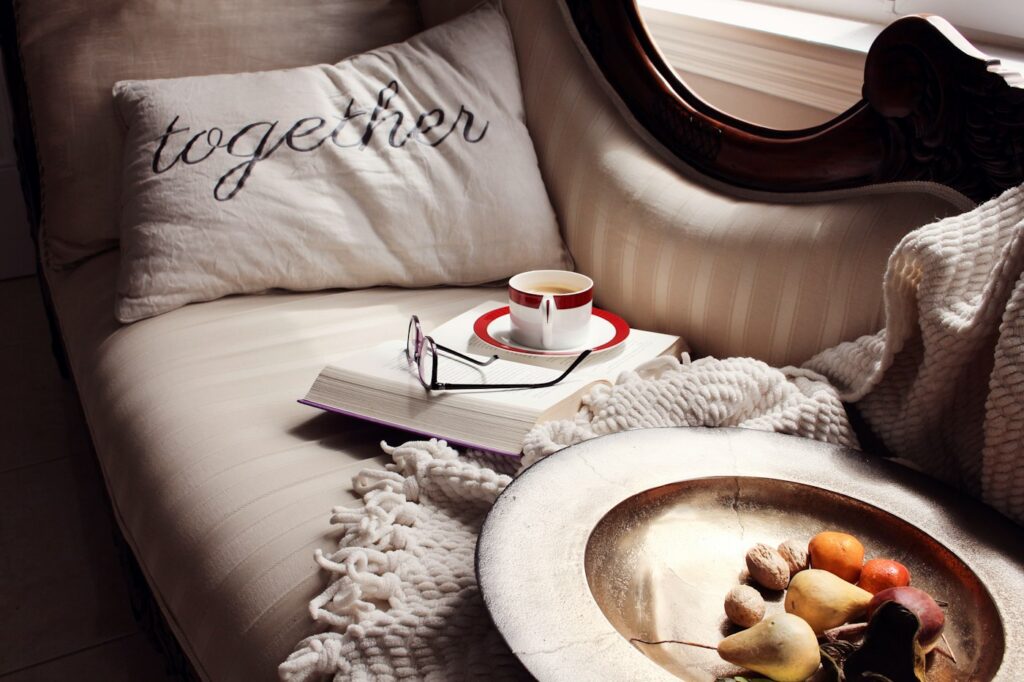 A cozy sofa with a book and a cup of tea